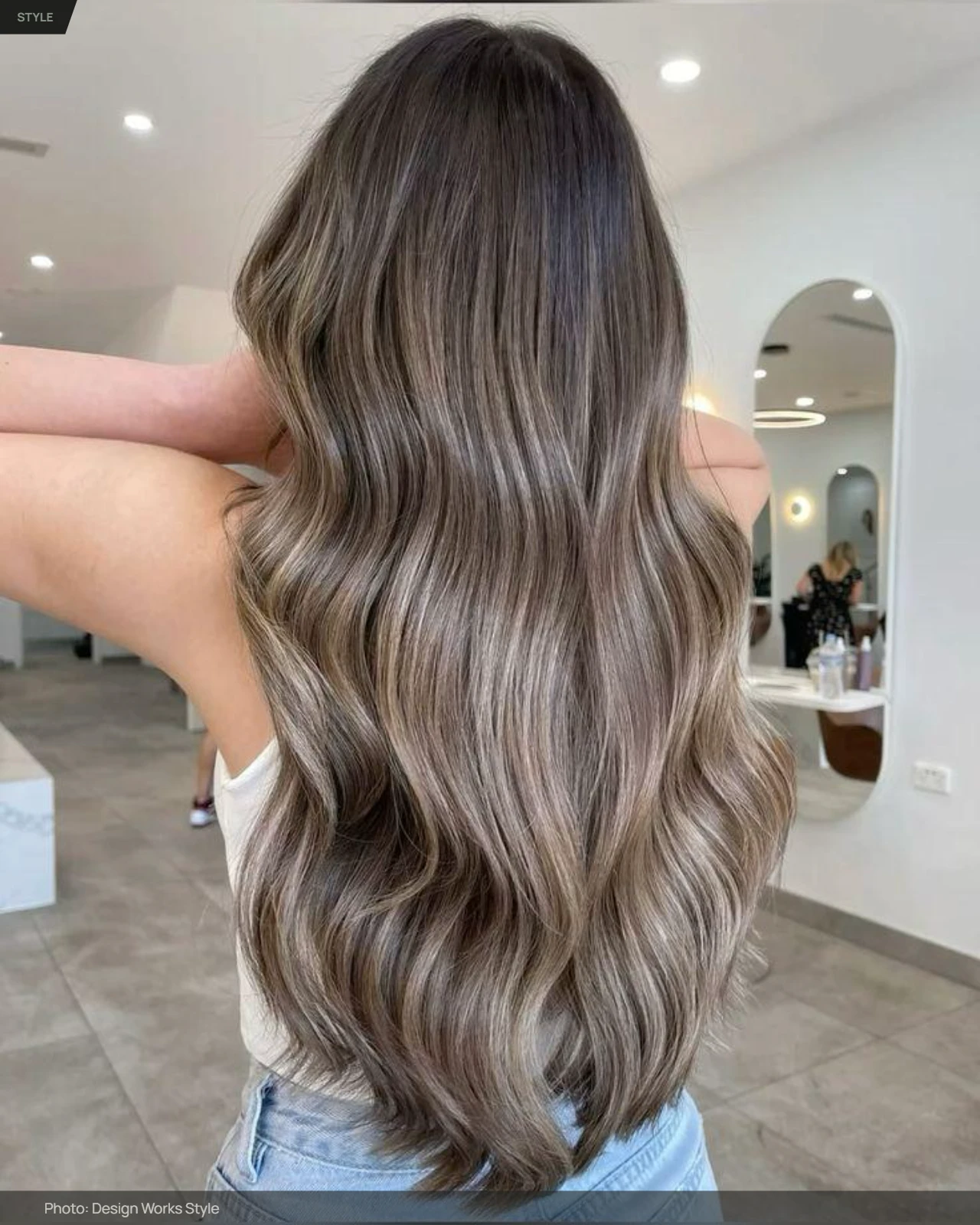 Ash brown balayage with cool muted brown pieces blended through wavy brunette hair