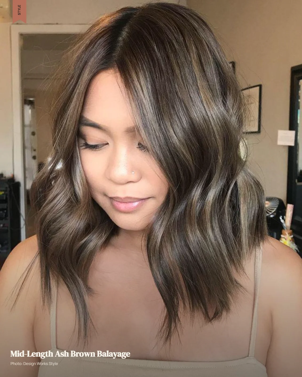 Ash brown balayage placed through the mid-lengths with darker roots remaining visible