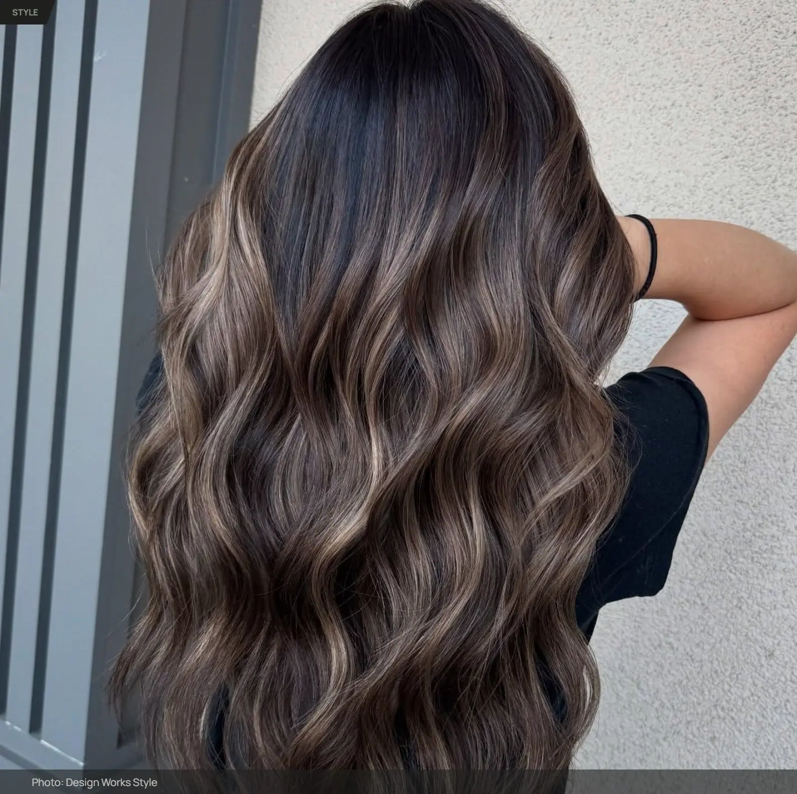Dark brown hair with lighter balayage pieces creating visible contrast through the lengths