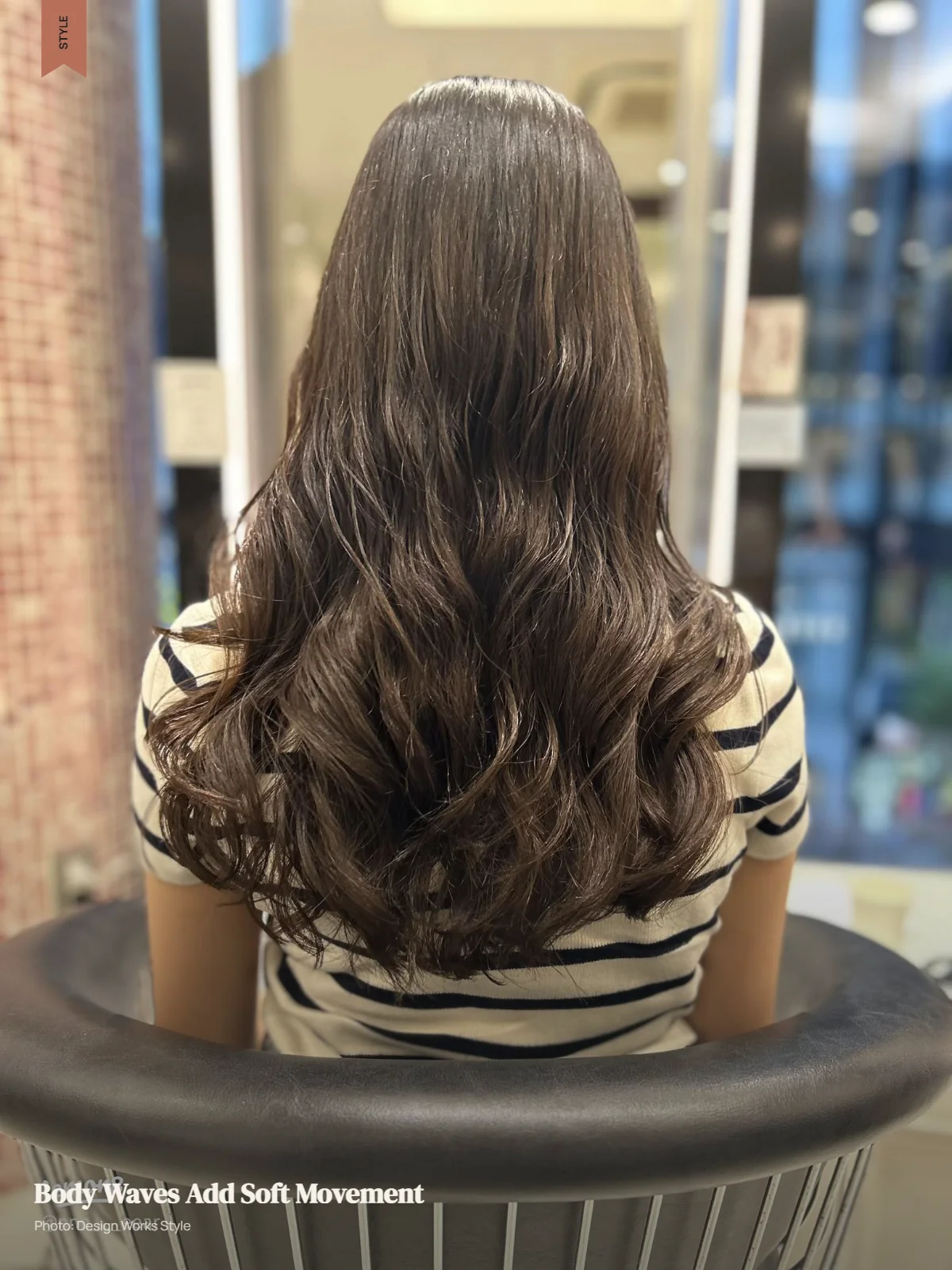 Long hair styled in broad body waves with soft volume and loose movement