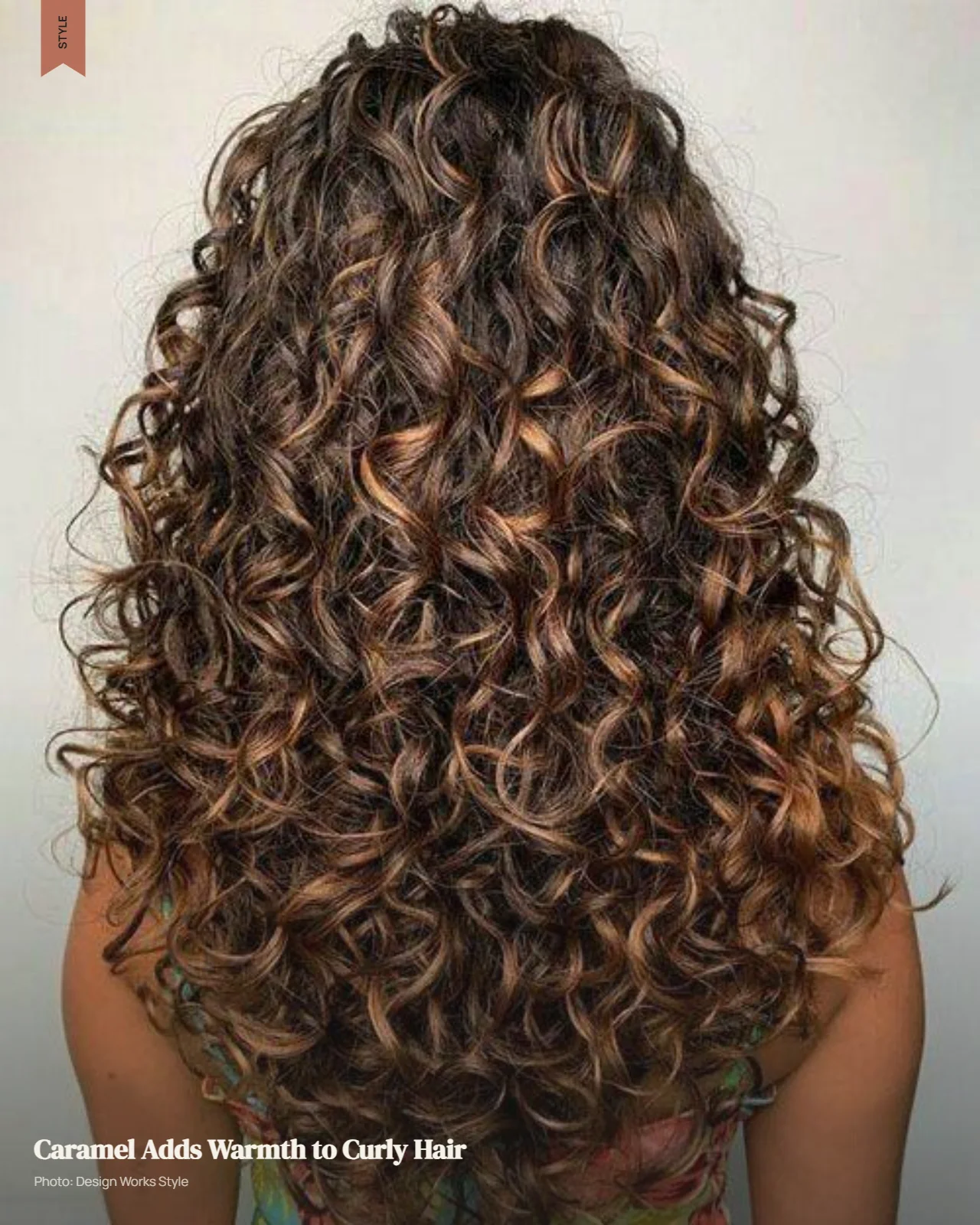 Curly dark brown hair with warm caramel balayage pieces creating visible tonal dimension