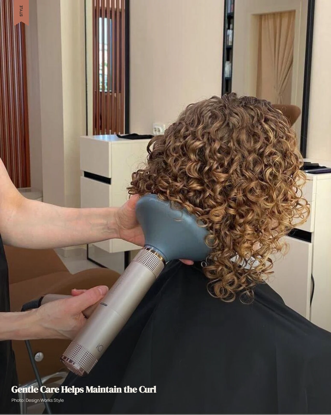 Stylist gently styling permed curls with a diffuser during a hair care routine
