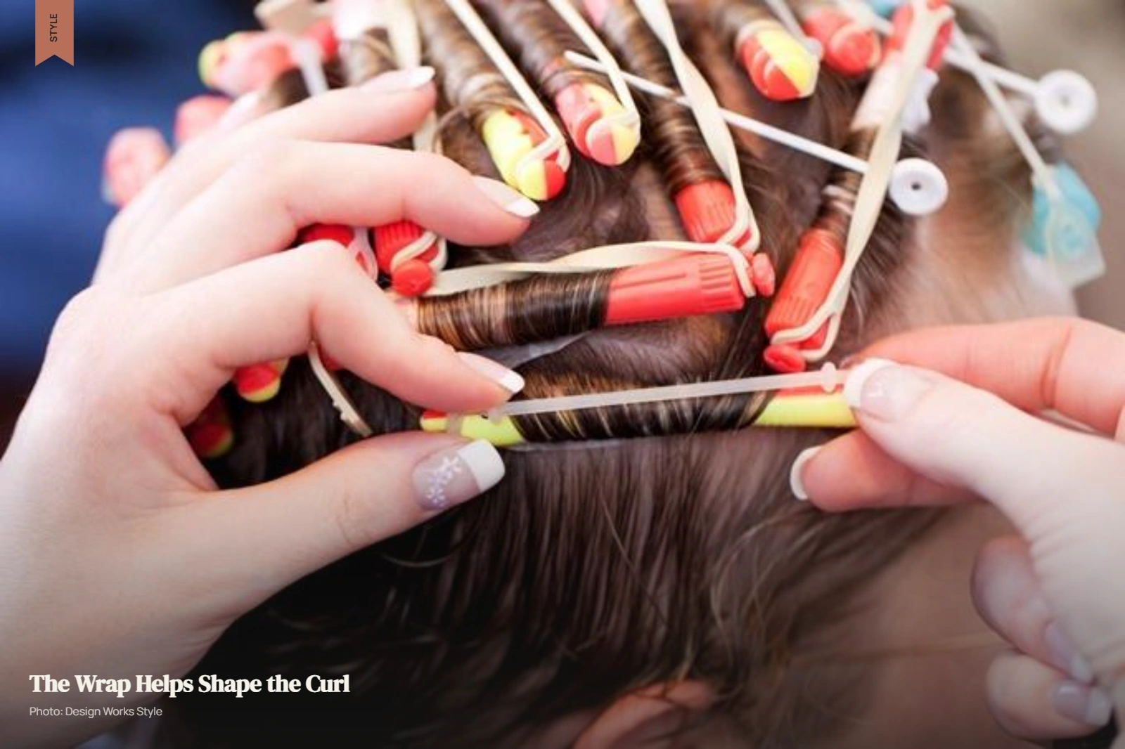 Stylist wrapping sectioned hair around perm rods during a cold perm