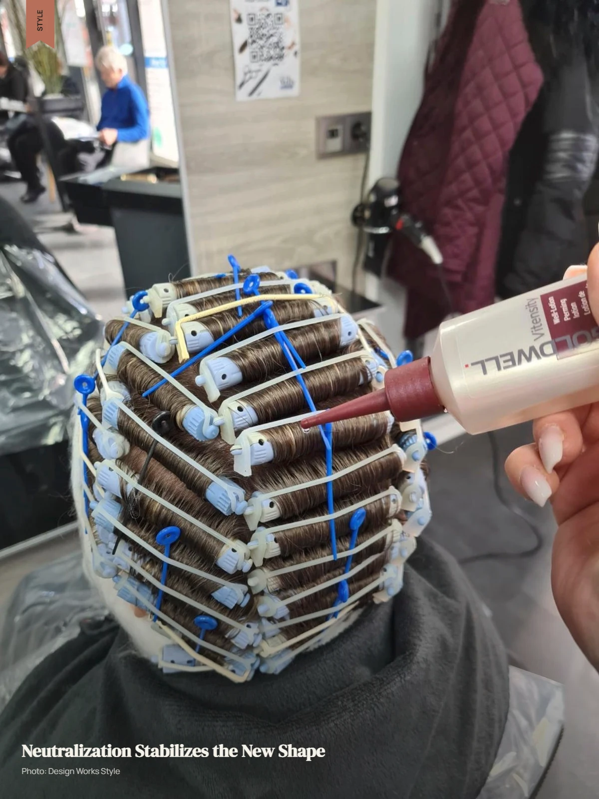 Stylist applying neutralizer to hair after the perming solution has processed