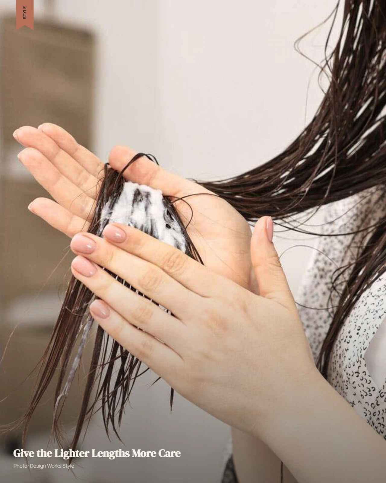 Hands working conditioner through wet balayage mid-lengths and lighter ends