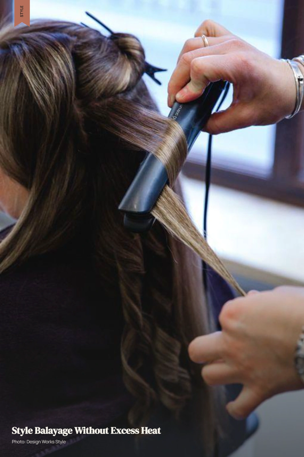 Flat iron styling balayage hair with lighter sections visible through the mid-lengths and ends