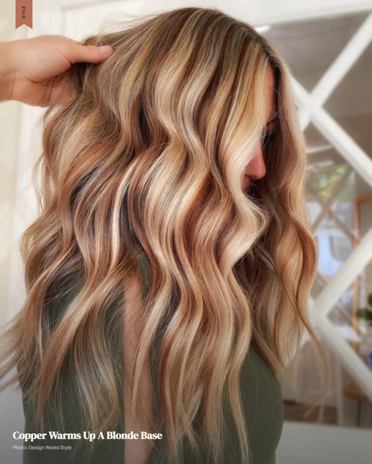Blonde hair with warm copper balayage pieces blended through the lengths