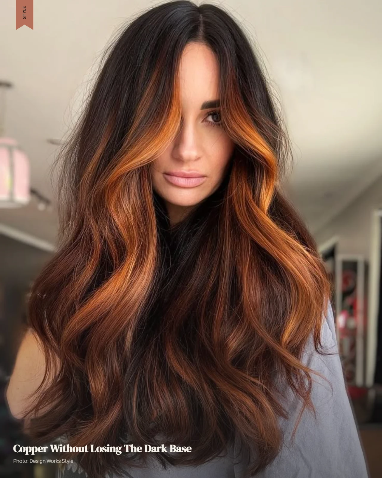 Dark brown hair with selective copper balayage pieces through the lengths