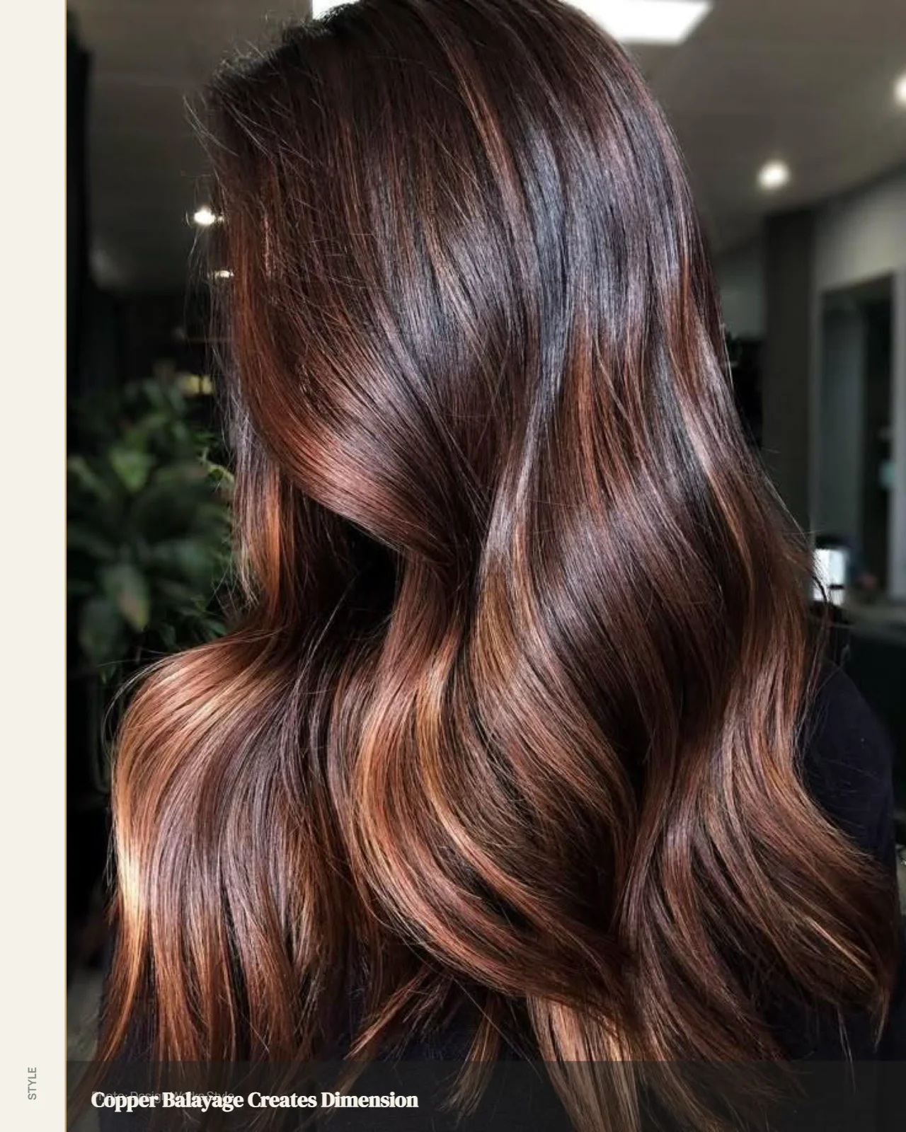 Dark brunette hair with warm copper balayage sections through the lengths