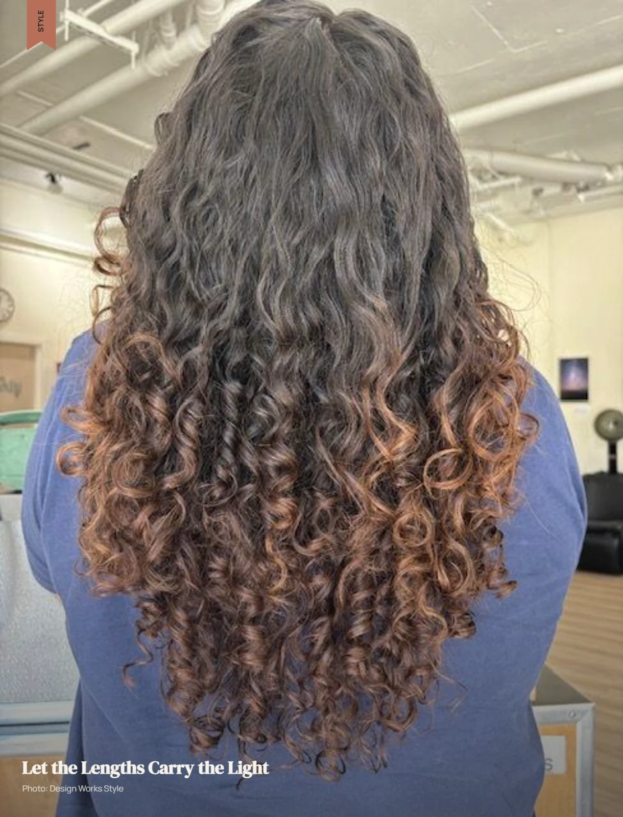 Curly hair with darker roots transitioning to lighter mid-lengths and ends