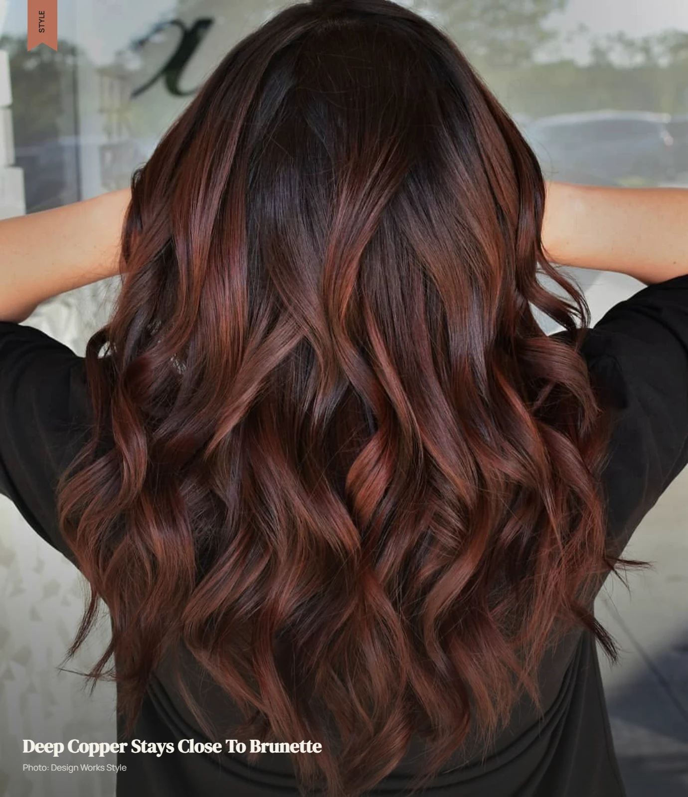 Deep copper balayage blended into brunette hair with darker sections remaining visible