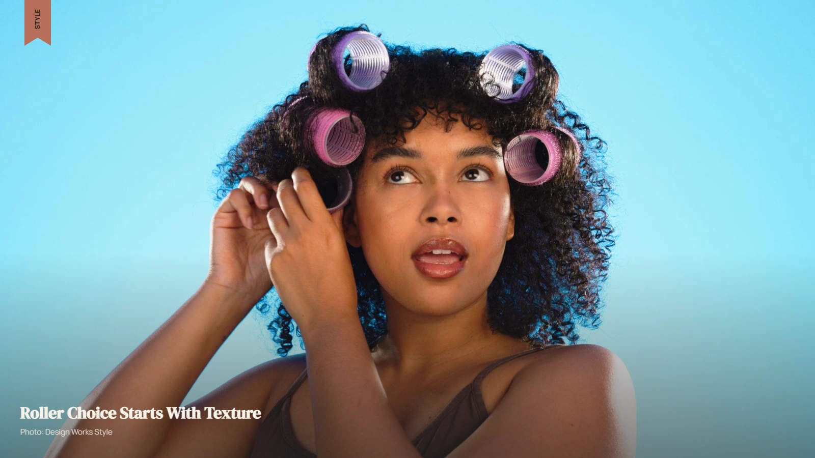 Curly hair sectioned and wrapped around flexi rods for defined curls