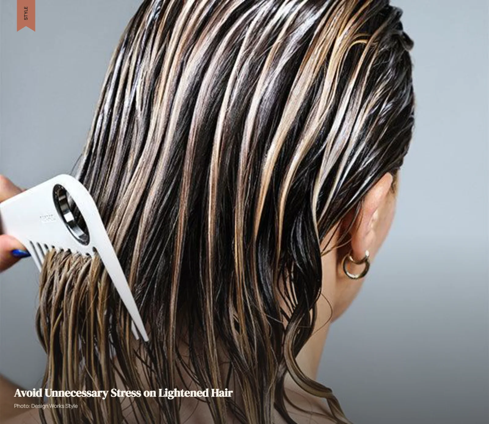 Wet balayage hair being gently detangled through the lighter mid-lengths and ends