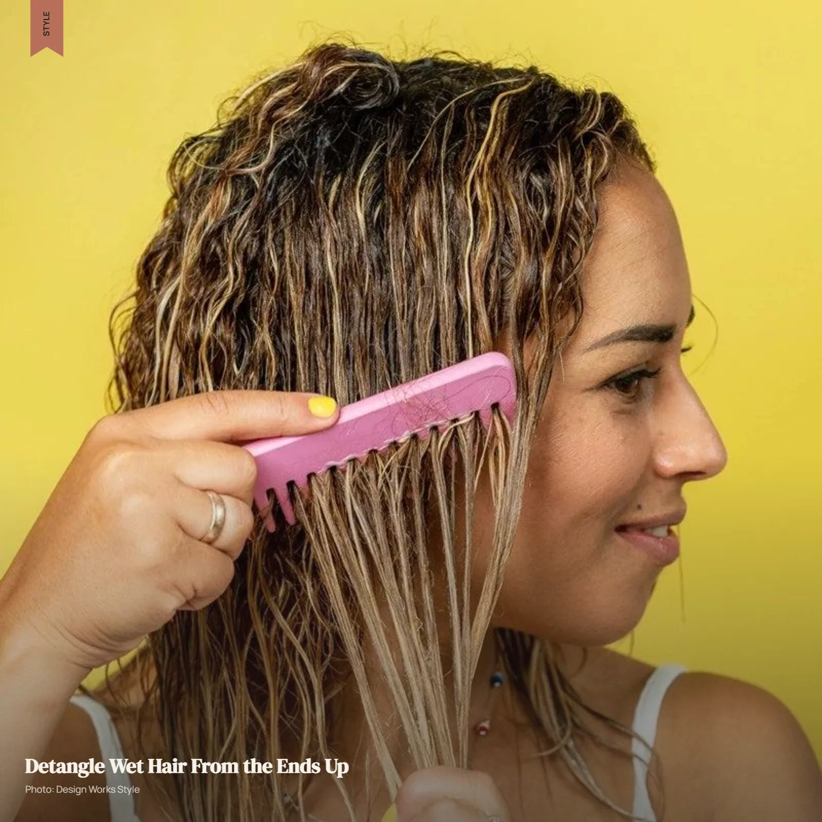 Wide-tooth comb gently detangling wet hair from the ends upward