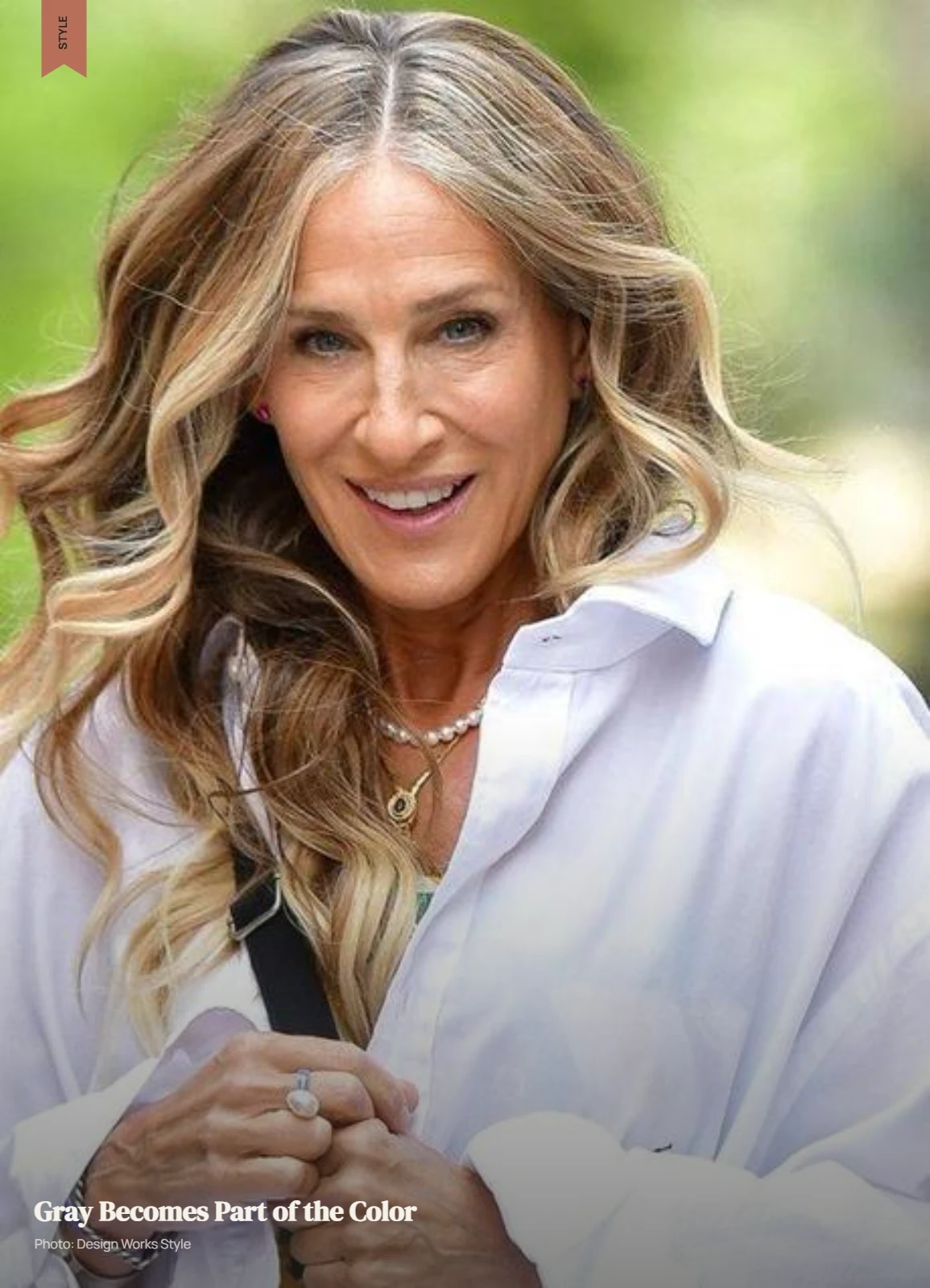 Woman with natural gray strands blended through dimensional highlighted hair