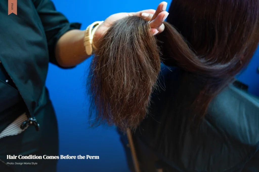 Stylist examining hair condition during a consultation before a perm service