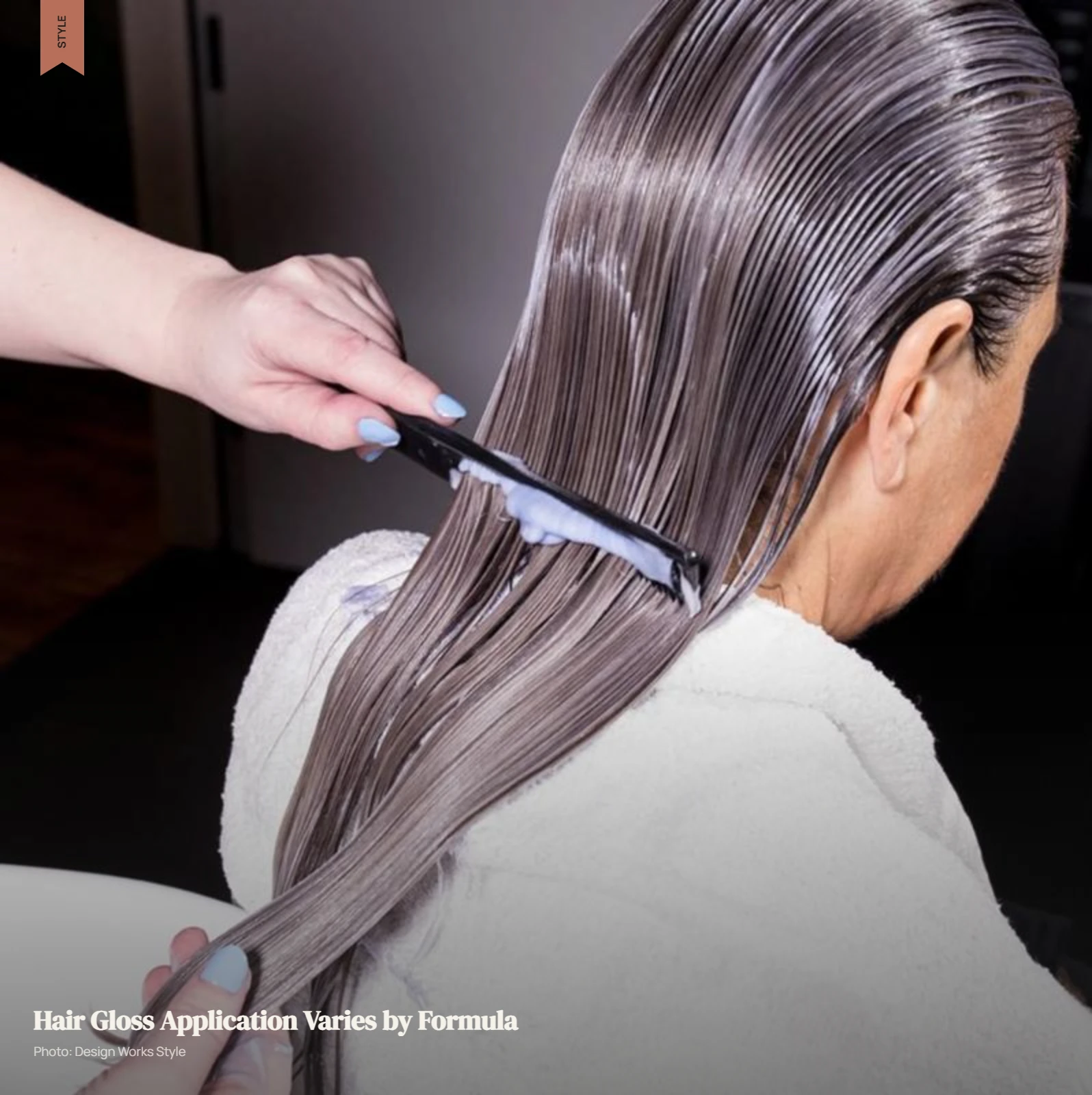 Stylist applying hair gloss with a tint brush through damp, sectioned hair