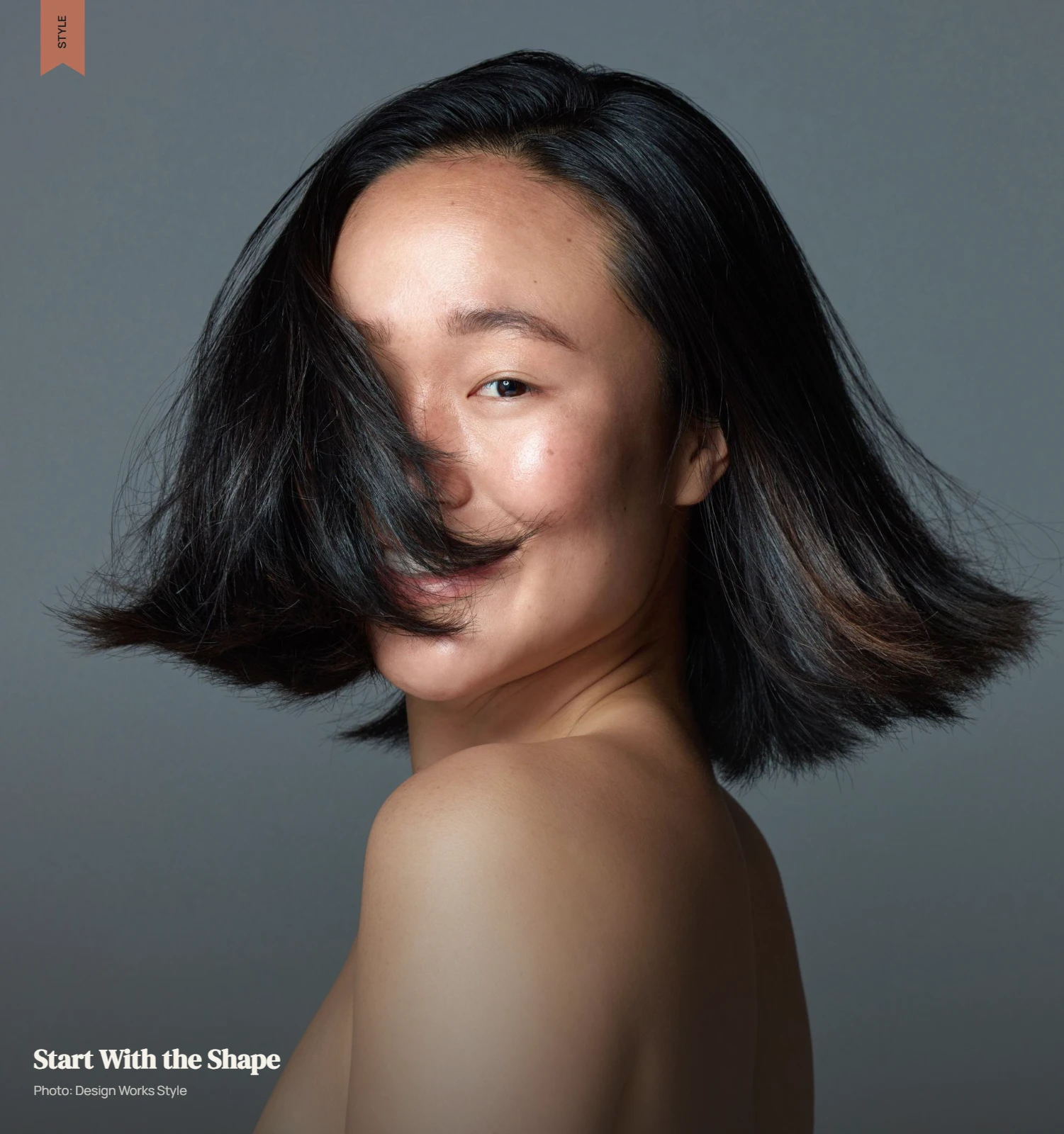 Editorial portrait showing a shaped haircut with visible layers and natural hair texture