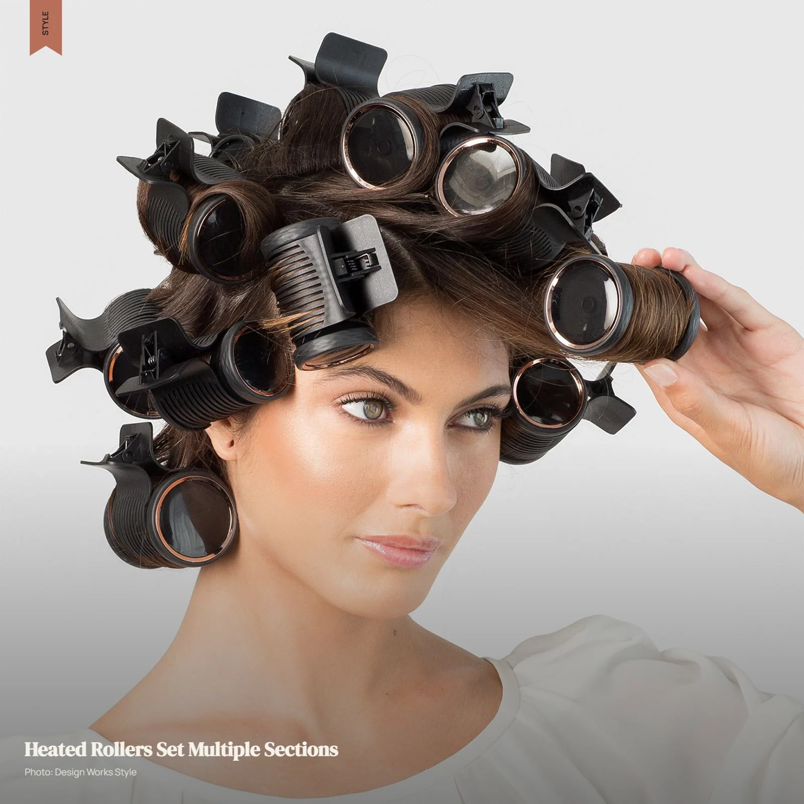 Heated rollers secured across multiple hair sections for curls and volume