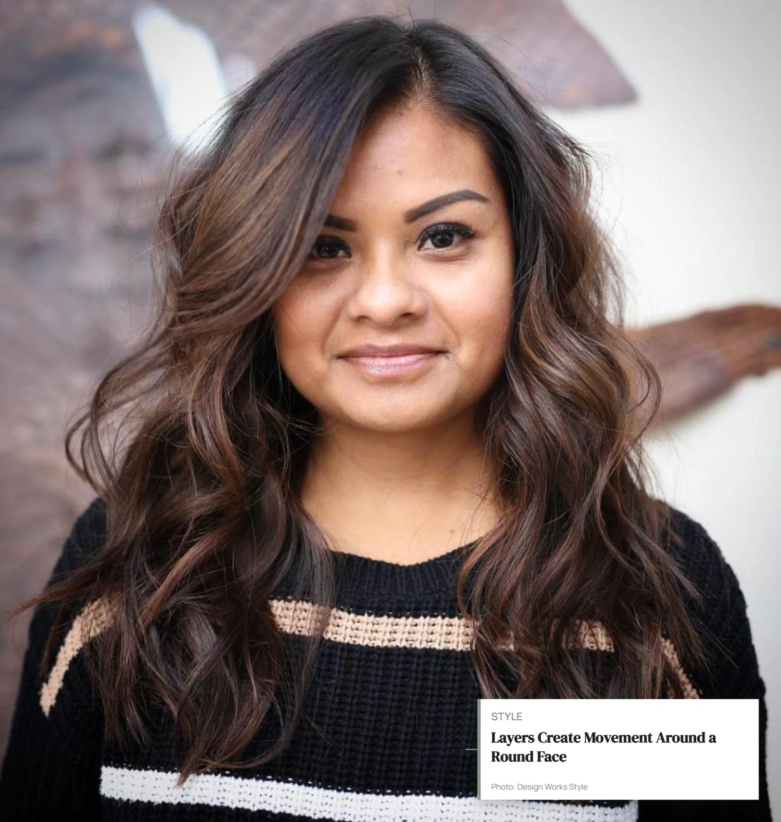 Medium-length layered haircut with face-framing pieces and movement below the cheeks