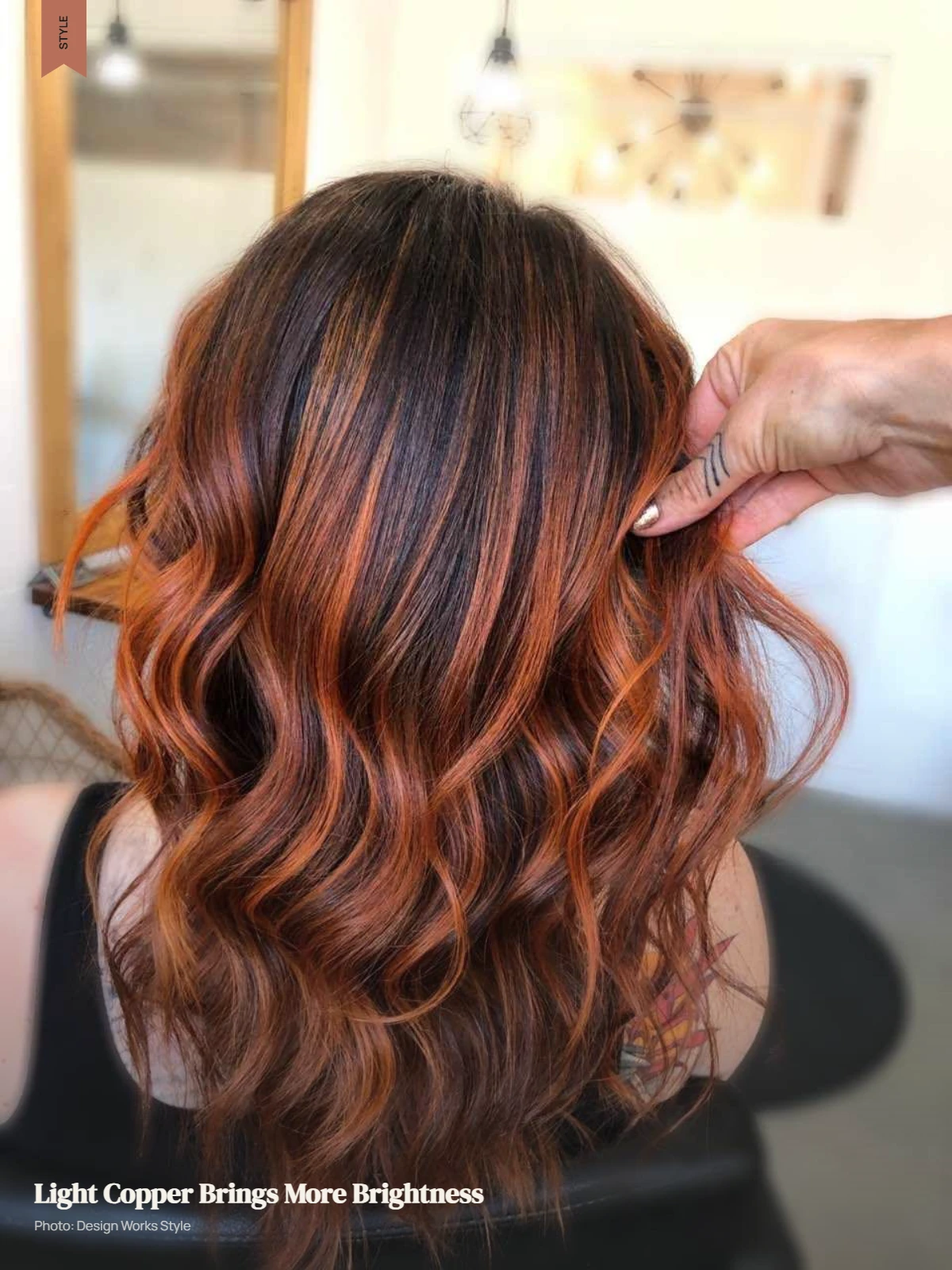 Brunette hair with bright light copper balayage sections through the lengths