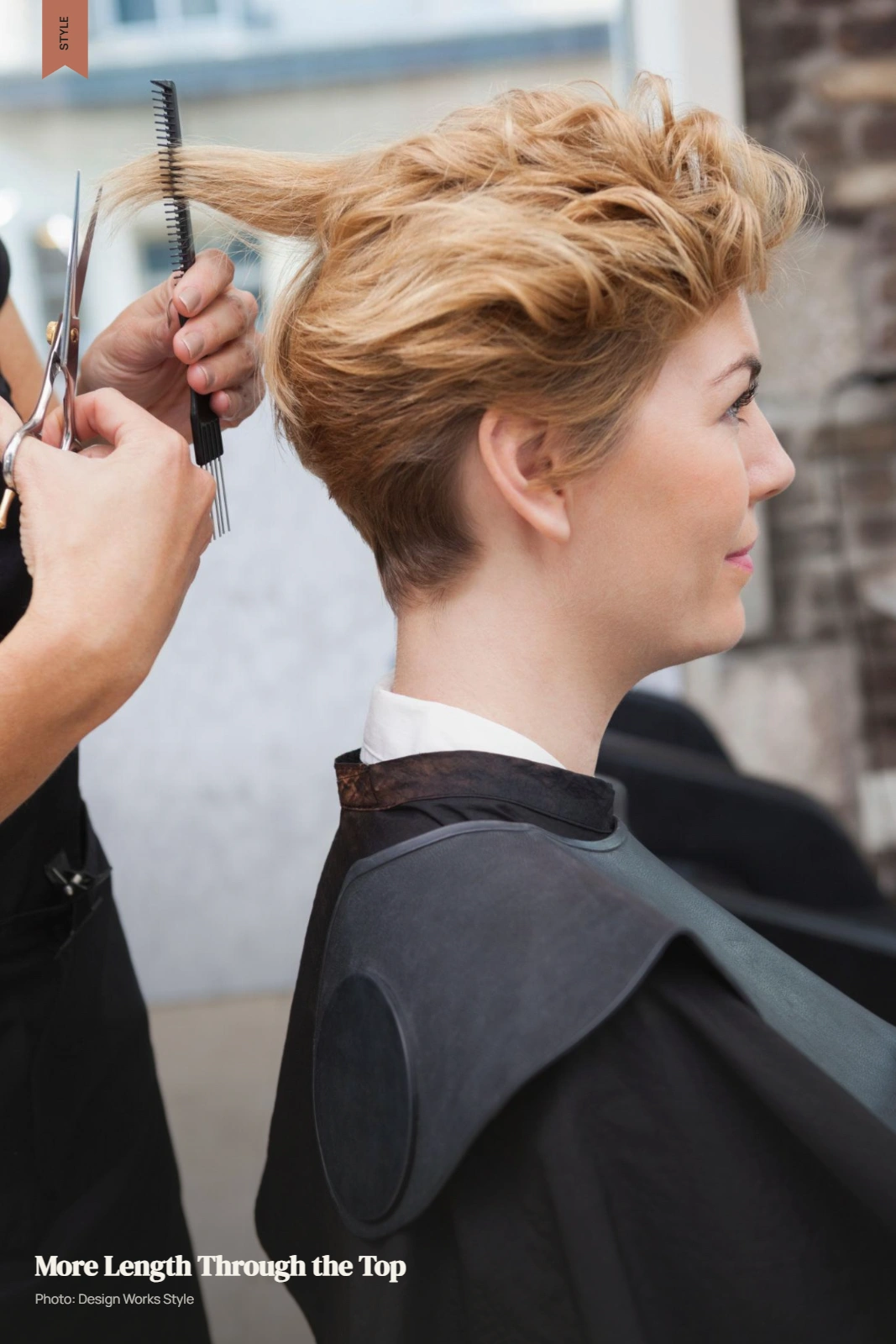 Stylist cutting a pixie with longer textured hair through the top in a salon