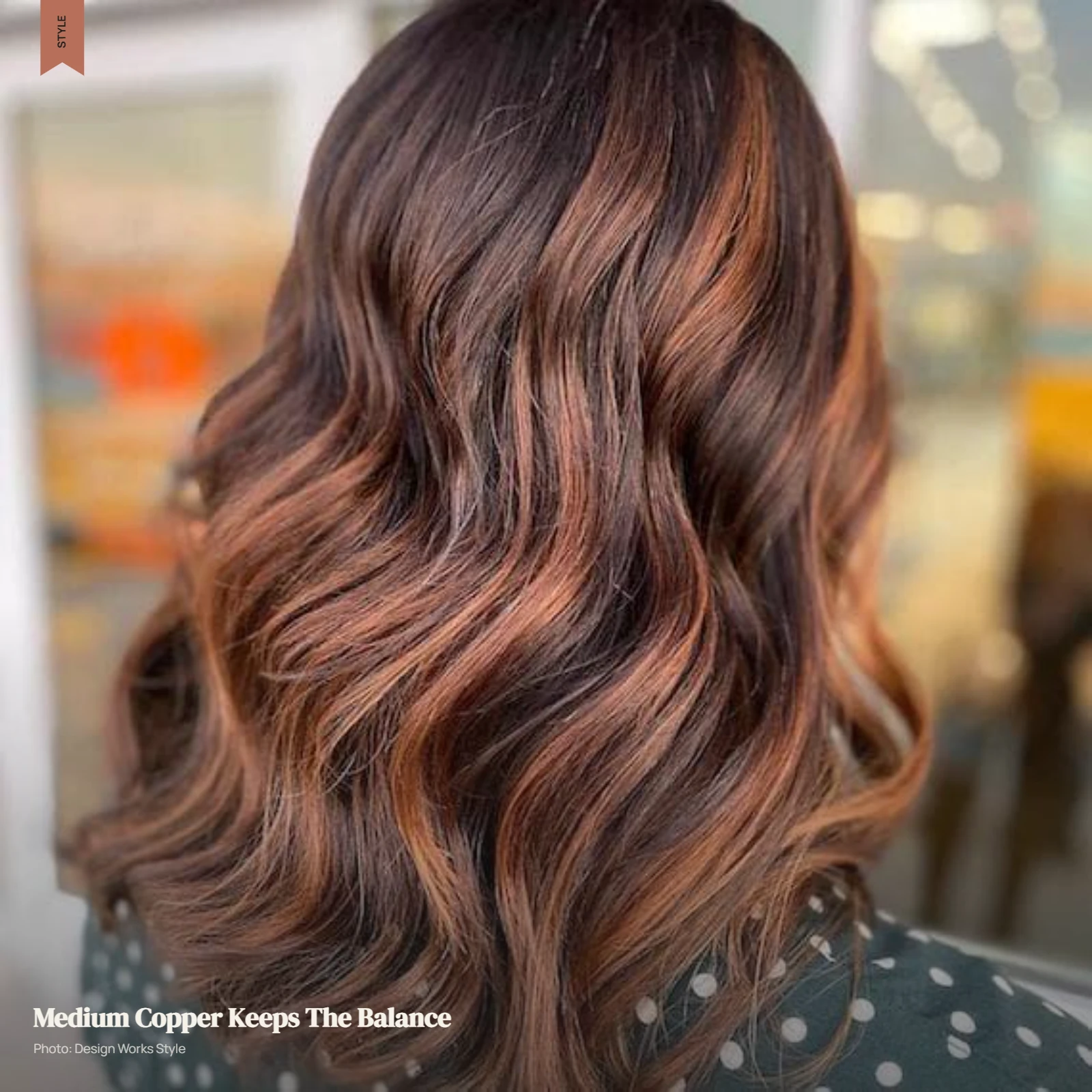 Medium copper balayage blended through brunette hair with darker sections remaining visible