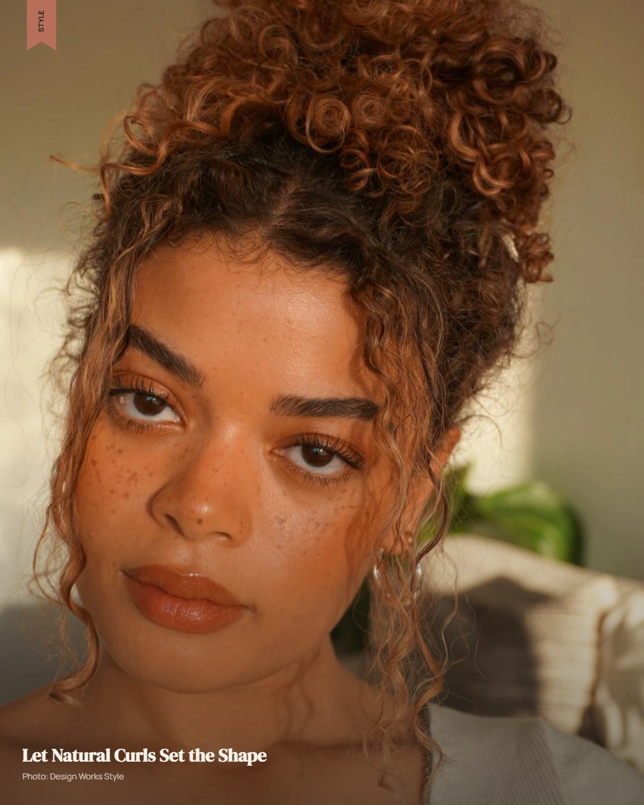 Natural curly hair worn loose with visible curl definition and full volume