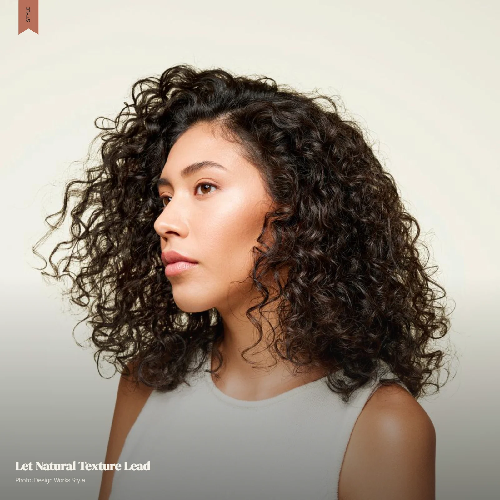 Natural wavy or curly hair with defined texture, movement, and controlled volume