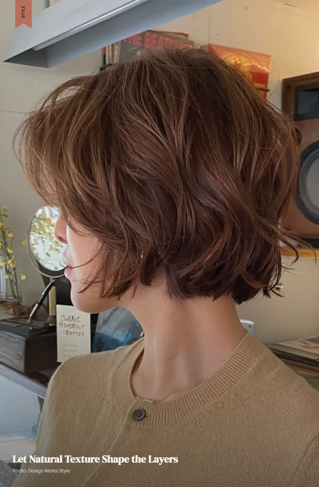 Short layered haircut on naturally wavy hair with visible texture and soft movement