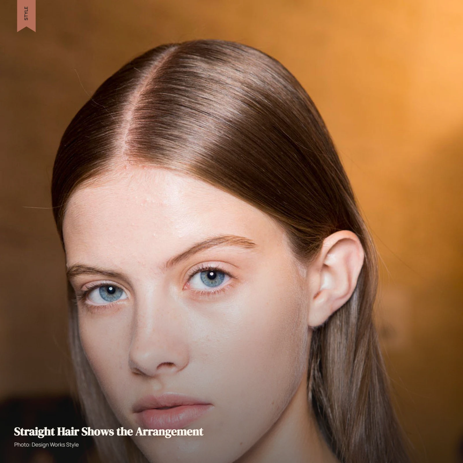 Straight hair with a defined part, directional styling, and a clean natural silhouette