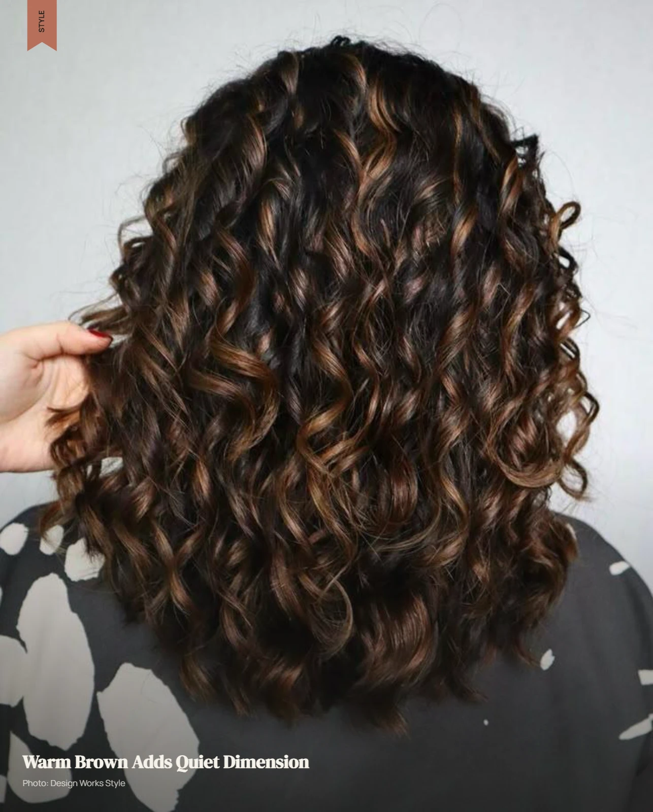Curly brown hair with subtle warm brown balayage pieces adding tonal dimension