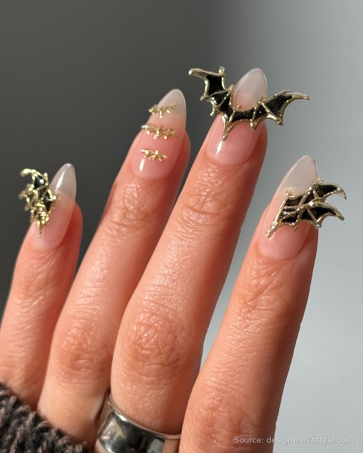 Nude Halloween nails with 3D black and gold bat charms