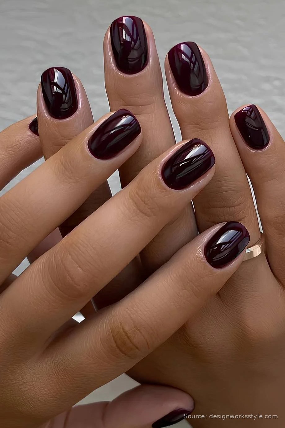 Glossy black cherry fall nails on short oval nails