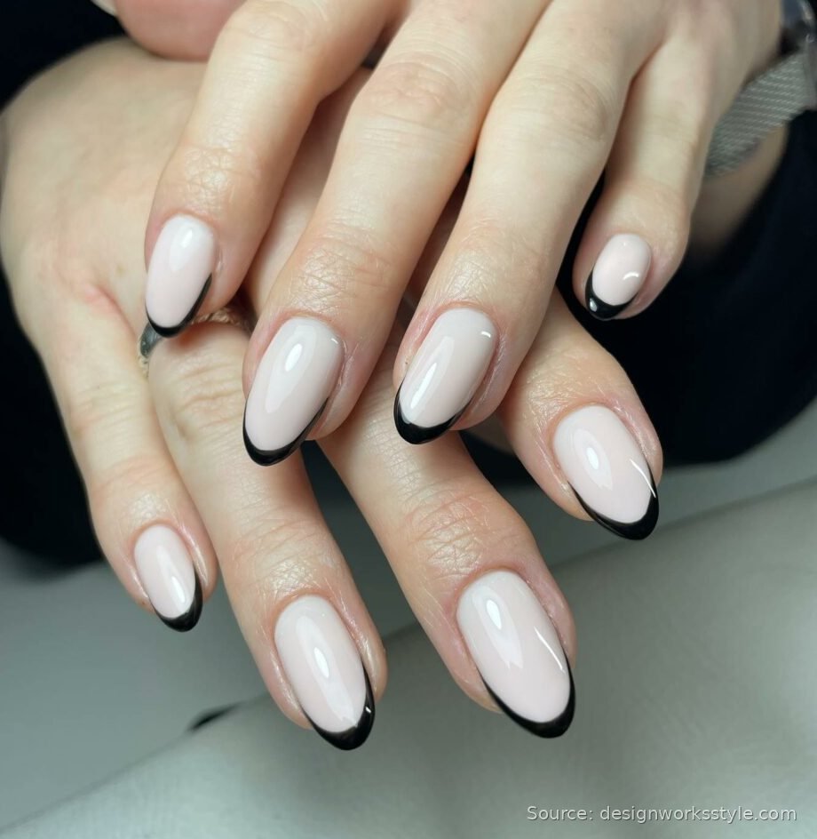 Black French tip nails on milky white almond nails