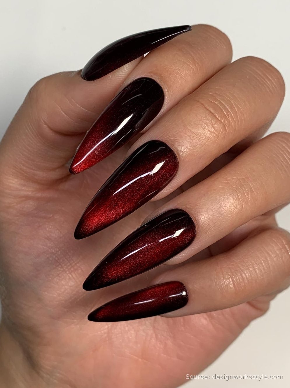 Blood red magnetic cat eye nails on long stilettos