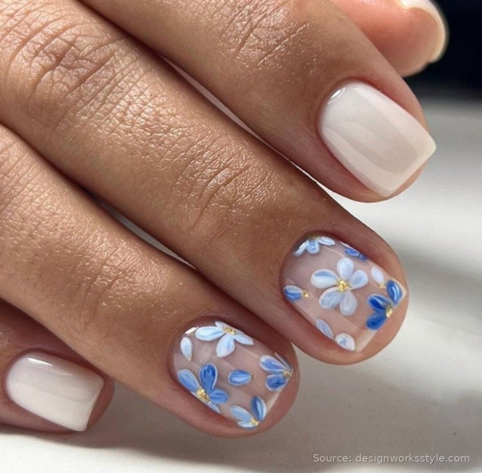 Blue tiny floral nail art on nude short nails