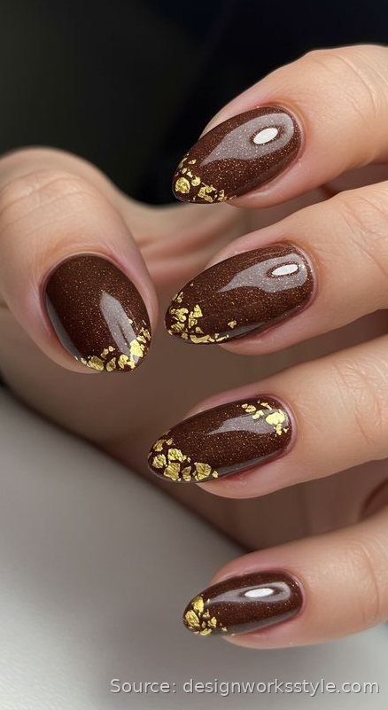 Deep brown nails with gold foil flake accents