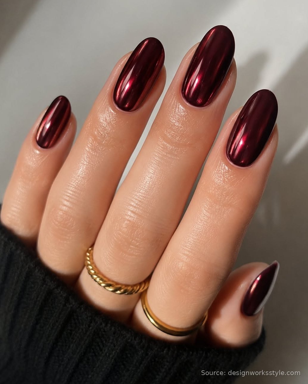 Burgundy chrome nails with a deep red metallic mirror shine