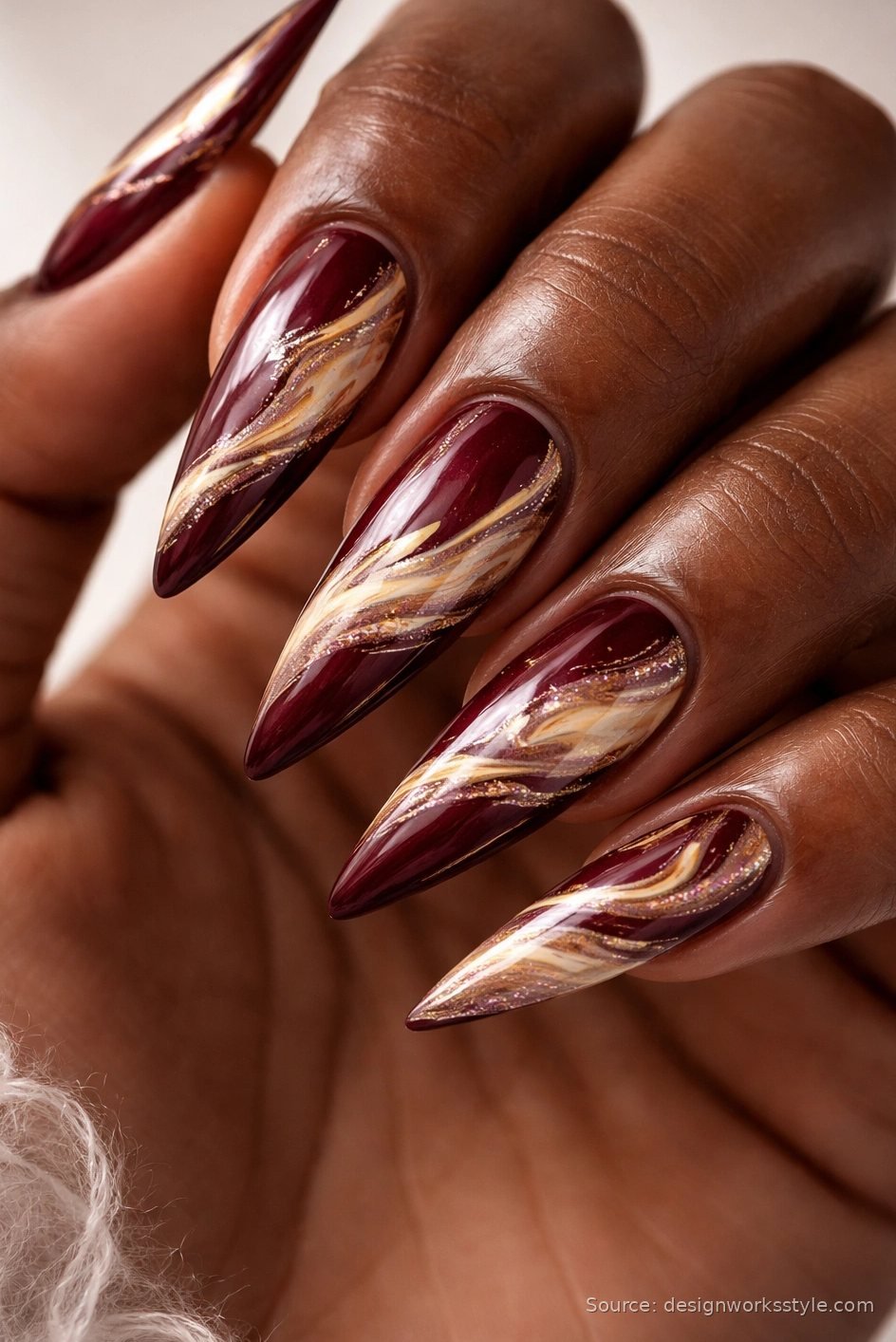 Burgundy and gold marble Christmas nails on stiletto shape