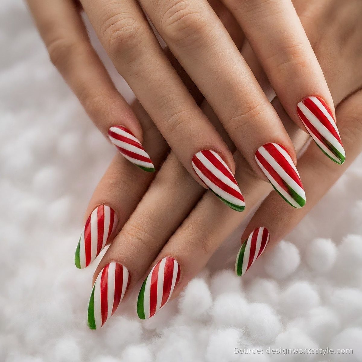 Red and white candy cane stripe Christmas nails with green tips
