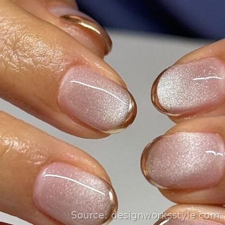 Champagne nude Christmas nails with gold French tips and shimmer