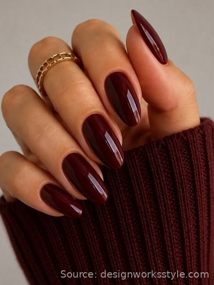 Glossy deep burgundy winter nails on almond shape