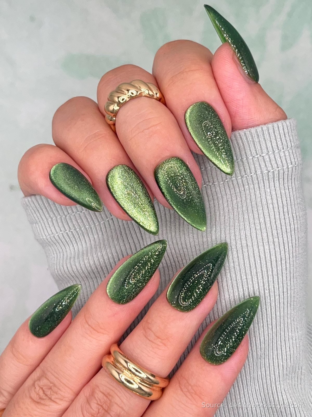 Deep emerald green magnetic cat eye nails with gold rings