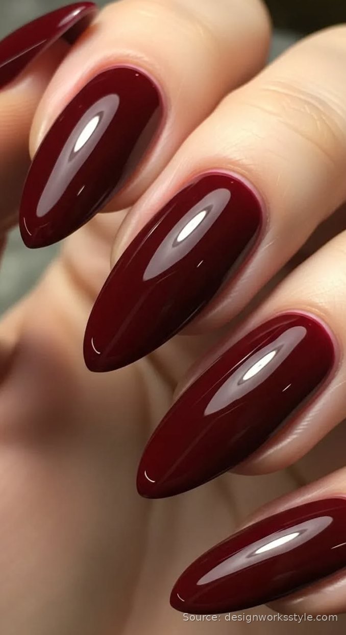 Deep red glossy fall nails on long almond nails