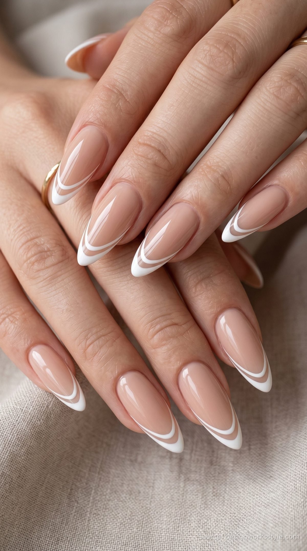 Double line white French tip nails on nude almond nails