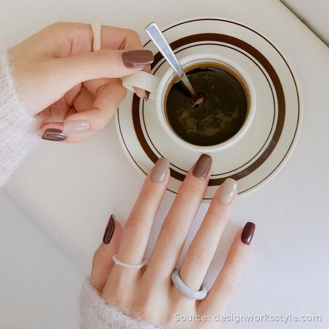 Espresso brown and nude alternating manicure styled with a coffee cup