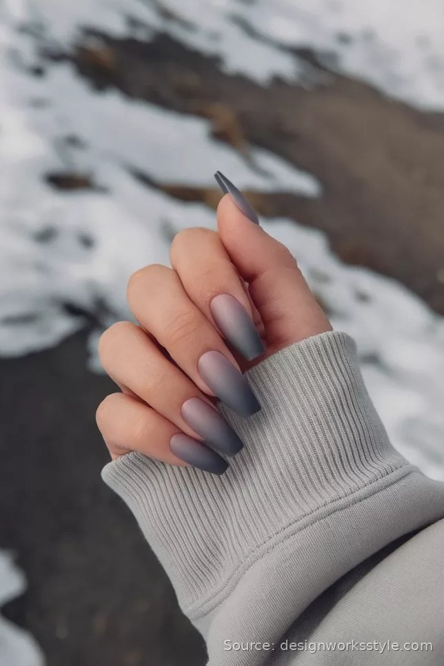 Matte foggy gray ombre winter nails on long coffin nails in snow
