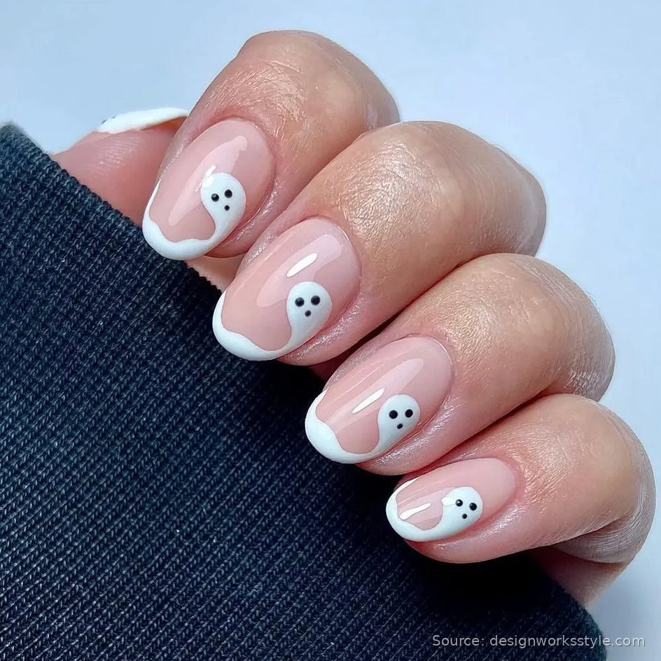 White French tip nails with tiny ghost faces for minimalist Halloween