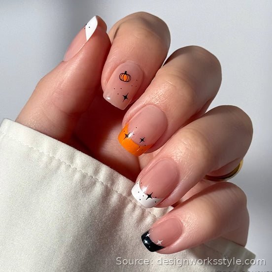 Nude nails with tiny pumpkin dot and mismatched Halloween French tips